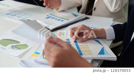 Data Analysis and Reporting. Close-up of hands reviewing business charts and graphs. Data Analysis and Reporting. Close-up of hands reviewing business charts and graphs. 128370053