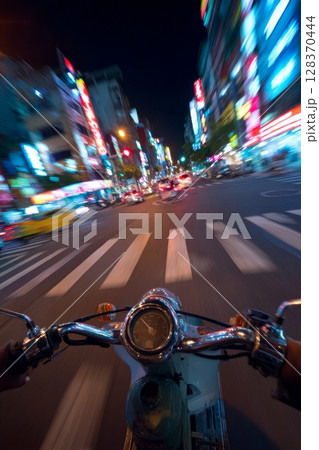 Dynamic POV of Scooter Crossing Busy Urban Intersection at Night 128370444