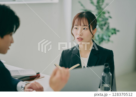 スーツ姿で仕事をする男女 スーツ姿で仕事をする男女 128370512