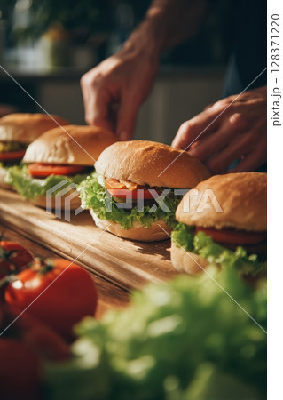 First-Person View of Assembling Fresh Burgers in Bright Kitchen Light 128371220