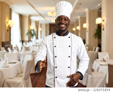 AI generated image of an executive chef in full whites gesturing to welcome diners into an elegant fine dining restaurant in a hotel. AI generated image of an executive chef in full whites gesturing to welcome diners into an elegant fine dining restaurant in a hotel. 128371854