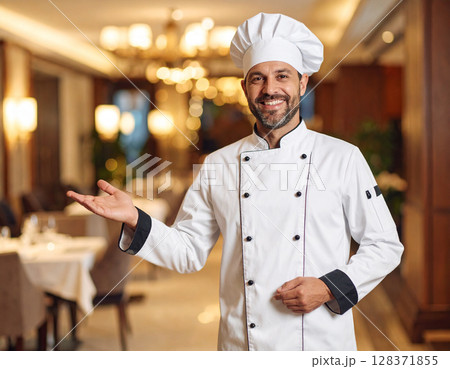 AI generated image of an executive chef in full whites gesturing to welcome diners into an elegant fine dining restaurant in a hotel. 128371855