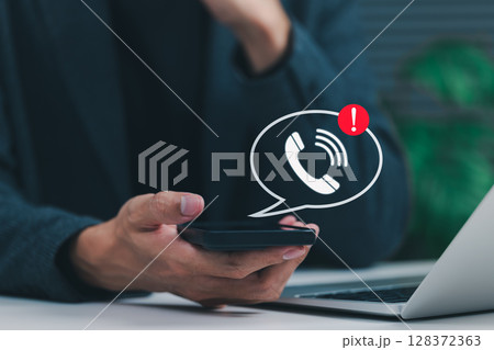 Phone Scam Alert and Warning Notification Concept. A person holding smartphone displaying call icon with alert symbol, representing scam call warnings, fraud awareness, digital communication threats, Phone Scam Alert and Warning Notification Concept. A person holding smartphone displaying call icon with alert symbol, representing scam call warnings, fraud awareness, digital communication threats, 128372363