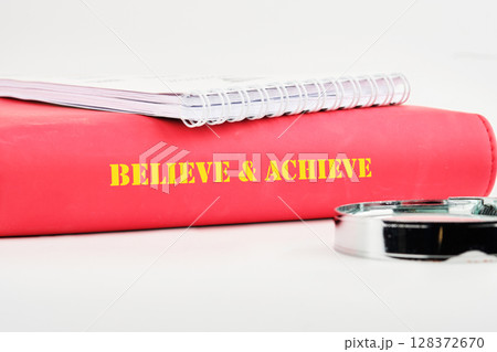 Inspiration quotes concept. BELIEVE and ACHIEVE words Inspiration quotes concept. BELIEVE and ACHIEVE words 128372670
