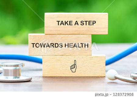 The concept phrase is TAKE A STEP TOWARDS HEALTH. Family values concept. lose up, copy space, background The concept phrase is TAKE A STEP TOWARDS HEALTH. Family values concept. lose up, copy space, background 128372908