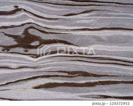 Fossil forest veneer surface with flowing lines in earthy espresso and misty grey tones. Fossil forest veneer surface with flowing lines in earthy espresso and misty grey tones. 128372952