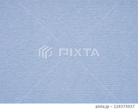 A serene blue paper texture, reminiscent of a tranquil sky, whispers of calm and quiet repose 128373037