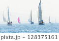 Sailing in morning haze. Regatta at the sea near the coast of Piraeus. 128375161