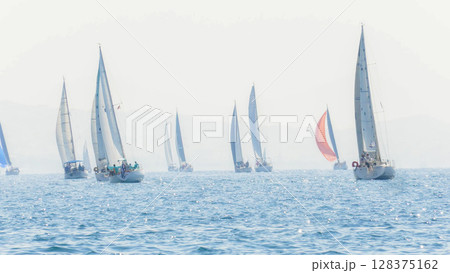 Sailing in morning haze. Regatta at the sea near the coast of Piraeus. Sailing in morning haze. Regatta at the sea near the coast of Piraeus. 128375162