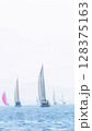 Sailing in morning haze. Regatta at the sea near the coast of Piraeus. 128375163