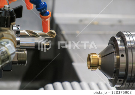 The multi tasking CNC lathe machine Swiss type bore cutting process the brass connector parts. The multi tasking CNC lathe machine Swiss type bore cutting process the brass connector parts. 128376908