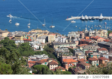 Camogli, Italy - 11 July 2025. Yachts, boats in bay of Liguria. Sea and tourism in Italy. Traditional buildings. Background for design. 128377089