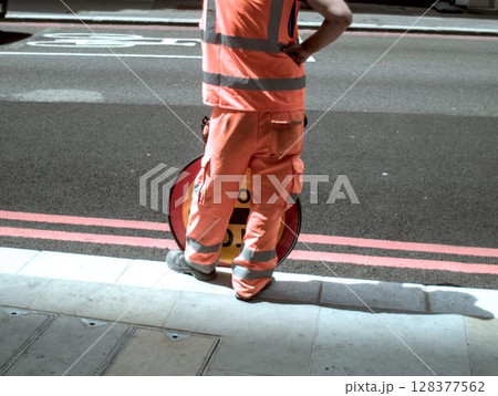 worker in safety uniform on road 128377562