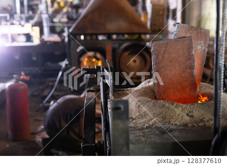 Ferrous metal billet is melted in an induction furnace closeup 128377610