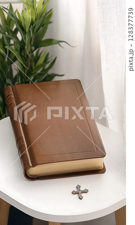 A brown book with a cross on top of it A brown book with a cross on top of it 128377739