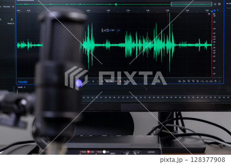 Studio microphone and monitor displaying green audio waveform for professional sound recording, podcast creation, and digital content Studio microphone and monitor displaying green audio waveform for professional sound recording, podcast creation, and digital content 128377908
