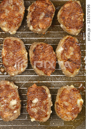 Savory minced meat and cheese patties 128378596