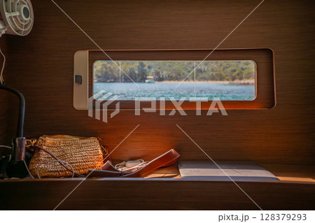 View from the cabin window of a sailing yacht anchored near Croatian islands. Peace, minimalism, slow living and connection with nature at sea. 128379293