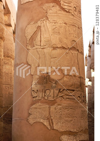 Ancient egyptian column with hieroglyphs and carvings at Karnak temple in Luxor, Egypt. 128379481