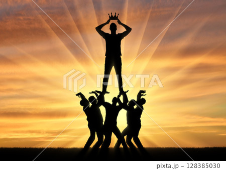 Silhouette of a selfish and narcissistic man dressing a crown, he stands on a crowd of men 128385030