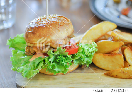 chicken burger or hamburger and french fries or chips 128385359