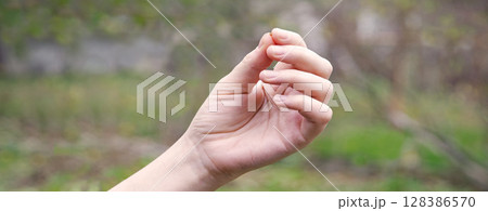 Hand holding a small mustard seed Hand holding a small mustard seed 128386570