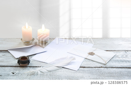Envelope and paper with pen on the table 128386575