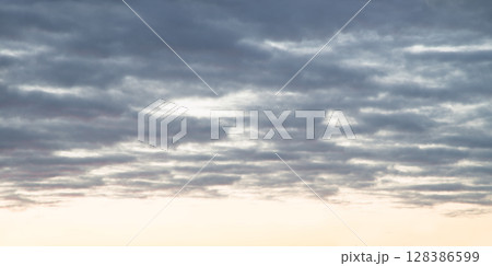 Bright clouds in the evening sky 128386599