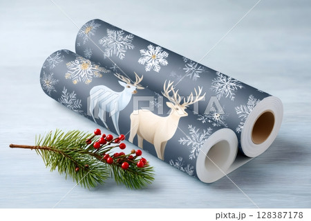 Two rolls of christmas wrapping paper with reindeer and snowflakes design 128387178