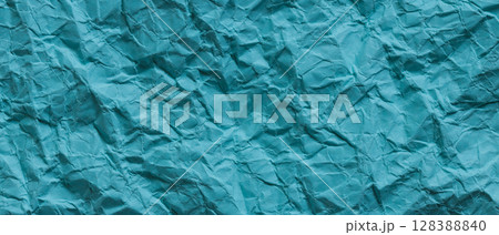 Crumpled Turquoise Paper Texture Background Close-Up 128388840