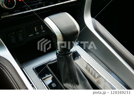 Automatic Gearbox Lever With Leather And Aluminum Trim In Business Car  128389231