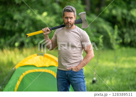 Lumberjack on outdoor camping. Brutal lumberjack. Brutality and masculinity. Hispanic lumberjack man with axe. Lumberjack axe. Man with logging axe. Masculine brutal man Lumberjack on outdoor camping. Brutal lumberjack. Brutality and masculinity. Hispanic lumberjack man with axe. Lumberjack axe. Man with logging axe. Masculine brutal man 128389511