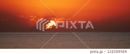 Vivid sunrise over the sea. Peaceful and captivating atmosphere. Nature background, relaxation concept, travel theme and inspirational visual Vivid sunrise over the sea. Peaceful and captivating atmosphere. Nature background, relaxation concept, travel theme and inspirational visual 128389564