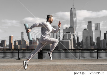 Man in sports suit training jogging. Running man in Manhattan. Morning sport workout jogger run in New York. Jogger run at sport training. Sportsman jogger running or jogging. Personal achievement Man in sports suit training jogging. Running man in Manhattan. Morning sport workout jogger run in New York. Jogger run at sport training. Sportsman jogger running or jogging. Personal achievement 128389593