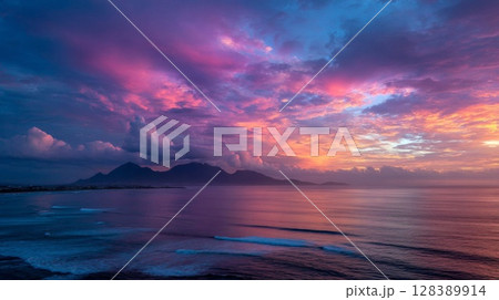 Vibrant Pink Purple Sunset Over Ocean and Mountains Vibrant Pink Purple Sunset Over Ocean and Mountains 128389914