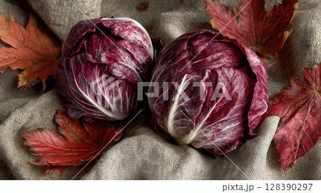 Two Red Radicchio Heads with Autumn Leaves on Linen Two Red Radicchio Heads with Autumn Leaves on Linen 128390297