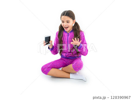 happy teen girl hold mobile phone in studio. teen girl hold mobile phone on background. 128390967