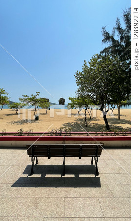 Outdoor beach, sands, trees, water, garden wooden bench in Hong Kong Repulse Bay Outdoor beach, sands, trees, water, garden wooden bench in Hong Kong Repulse Bay 128392214