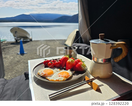Landscape photography from tent with breakfast food, strewberry, egg, tomato, coffee 128392220