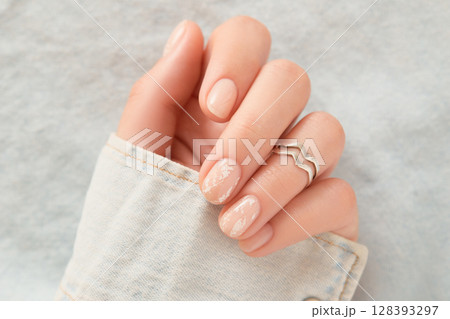 Beautiful womans hands with nude nail design. Manicure, pedicure beauty salon concept 128393297