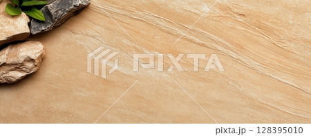 the image features a background of textured tan material with subtle, flowing lines 128395010