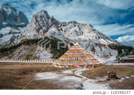 Colorful Tibetan Prayer Flags near Shambhala Pagoda in Balagezong with Snow Mountain Background 128398237