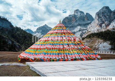 Colorful Tibetan Prayer Flags near Shambhala Pagoda in Balagezong with Snow Mountain Background 128398238
