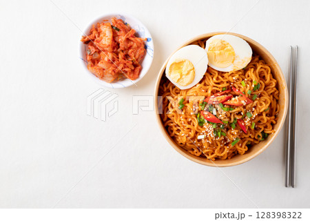 Spicy Korean dried instant noodles with boiled egg, scallions, sesame seed, chili and kimchi Spicy Korean dried instant noodles with boiled egg, scallions, sesame seed, chili and kimchi 128398322
