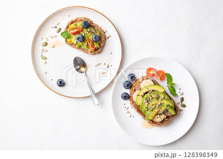 Avocado toast with banana, sunflower seeds, pumpkin seeds, sesame seeds, blueberry, tomato and honey Avocado toast with banana, sunflower seeds, pumpkin seeds, sesame seeds, blueberry, tomato and honey 128398349