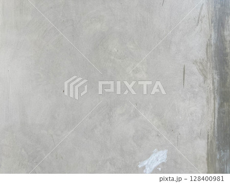 concrete wall with a plaster on a wall 128400981
