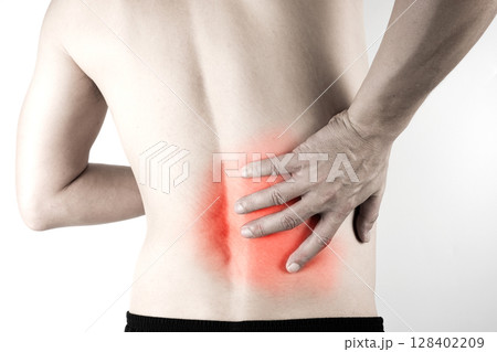 A man presses his hand against his back, has back pain and bone pain. 128402209