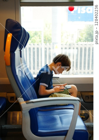 Child Engaged with Tablet on Train Journey 128402236