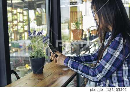 Asian woman holding smartphone with E-commerce Shopping online website Reading Online Article, Blog, vlog. Young Woman hands holding phone technology lifestyle. Happy Woman using digital smart phone Asian woman holding smartphone with E-commerce Shopping online website Reading Online Article, Blog, vlog. Young Woman hands holding phone technology lifestyle. Happy Woman using digital smart phone 128405303