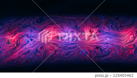 Fabulous paint flow. Gasoline texture. Pink purple color ink soap stream art light reflection. Dye mix defocused abstract black background. 128405462